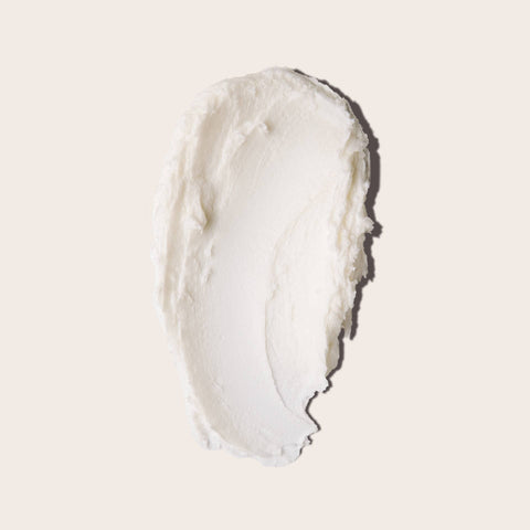 Close-up of a swatch of white cream, Everist shampoo on a beige background